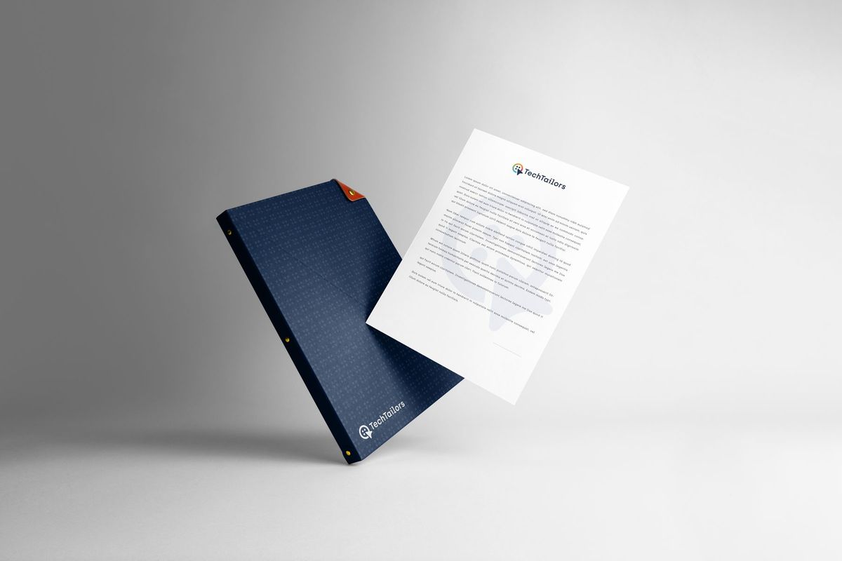 A navy folder printed with the dot pattern, and a letterhead sheet with the TechTailors logo at the top.